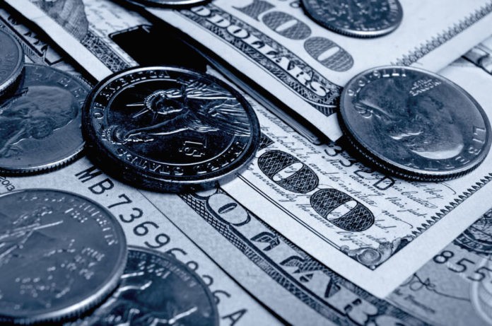 Dollar bills and coins close up shot