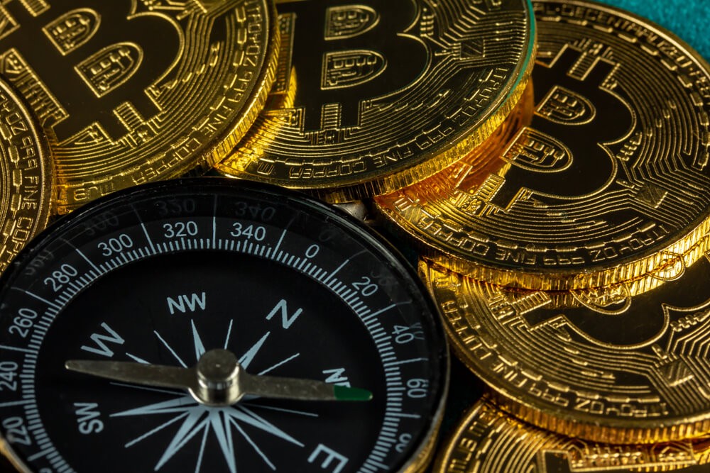 Bitcoins grouped around a compass