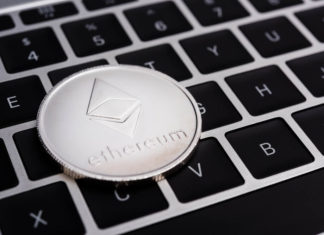 Ethereum coin on top of keyboard