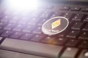 Ethereum coin on top of keyboard 