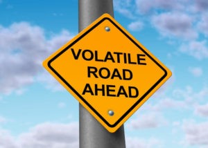 volatile road ahead on a sign post 