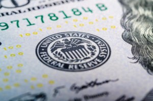 closeup shot of a dollar bill with federal reserve logo 