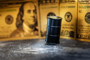 miniature oil barrel with Benjamin Franklin on the background