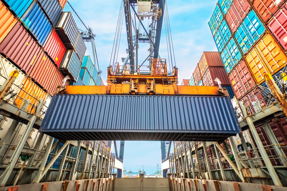 Wibest Broker — Shipping: Container loading in a Cargo freight ship wit industrial crane.