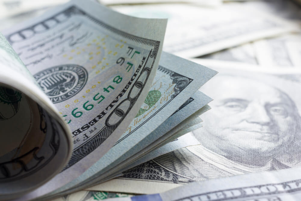 Wibest – US dollar with blurry dollar background.