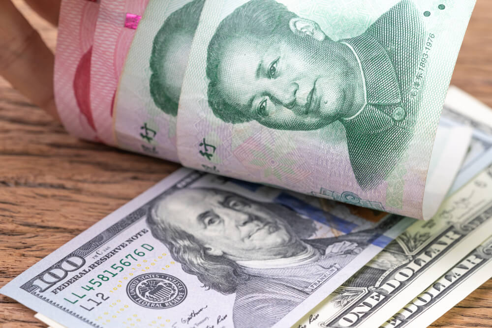 Wibest – US dollar banknotes face up to Chinese Yuan banknotes.