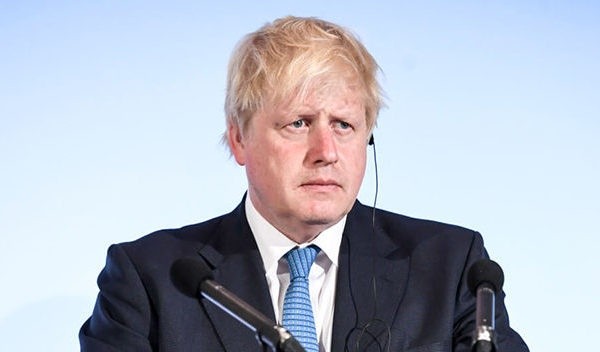 Wibest – British Prime Minister: Boris Johnson standing behind a podium.