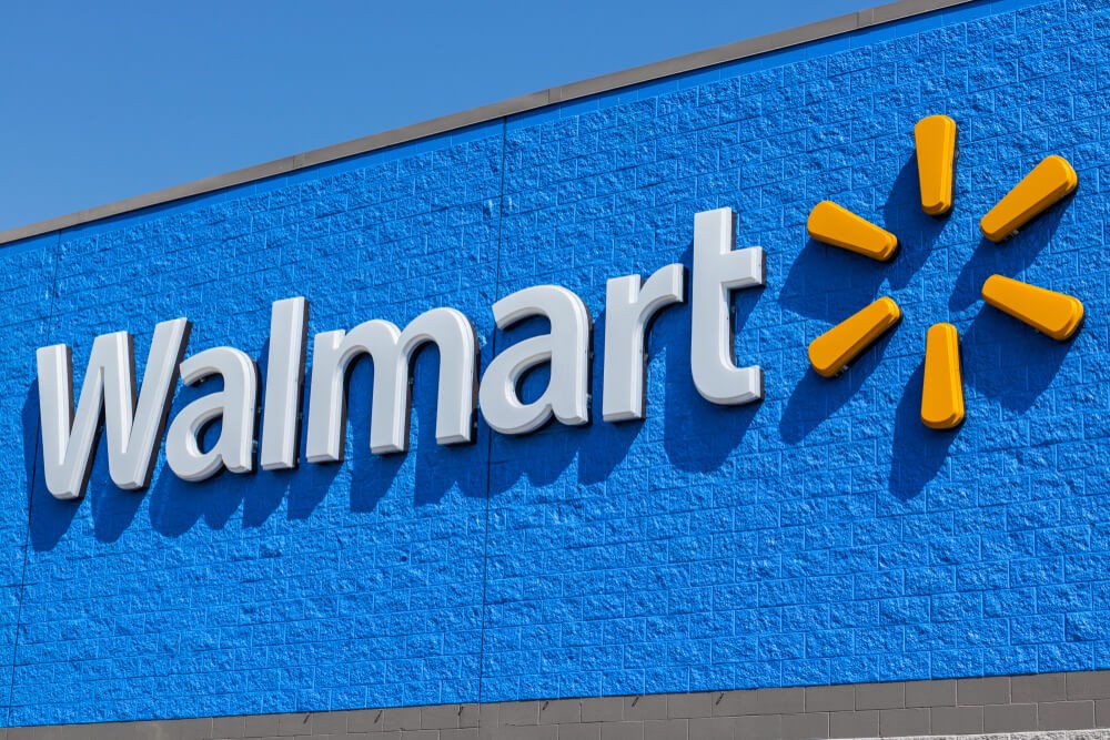 Digital Coins: Walmart logo in white color with sun on the side and blue background.