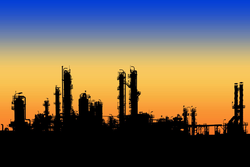 Petroleum Products: Oil and gas refinery tower in silhouette image on sunset sky background.