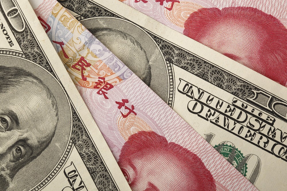 Forex Markets: Chinese yuan and US dollar bills.