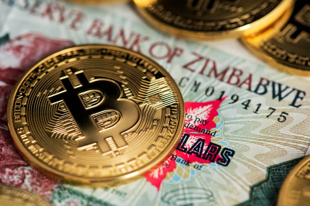 Digital Coins: Bitcoin Cryptocurrency on Zimbabwe hyperinflation banknote.