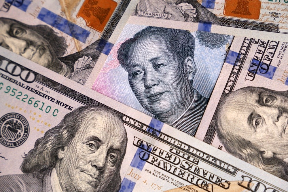 Wibest – Yuan: US dollar and Chinese yuan bills.