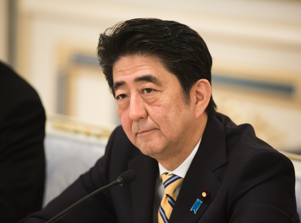 Wibest – US President: Japanese Prime Minister Shinzo Abe sitting in front or a mic.