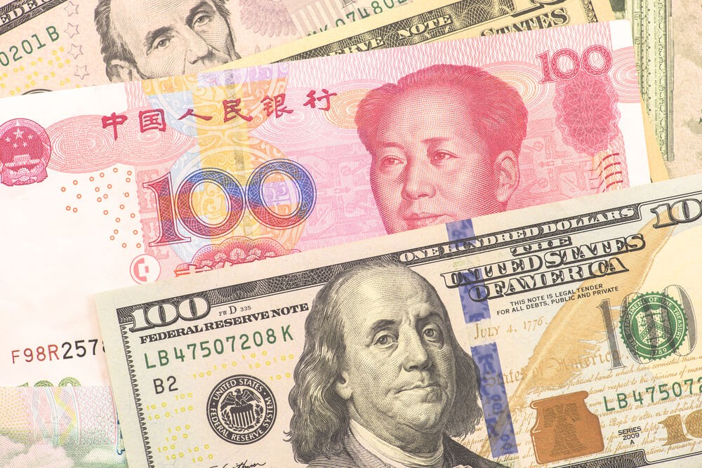 Forex Markets: Yuan and Dollar banknotes.