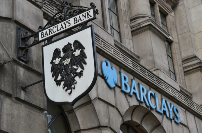 Barclays: Barclays bank old hanging street sign and modern logo next to it.
