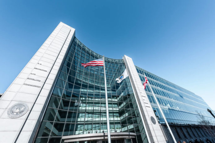 Sec Chairman: United States Securities and Exchange Commission SEC entrance architecture modern building sign, entrance, american flag, looking up sky, glass windows.