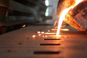 Wibest – Gold and Silver Prices: Molten metal poured from a crucible.