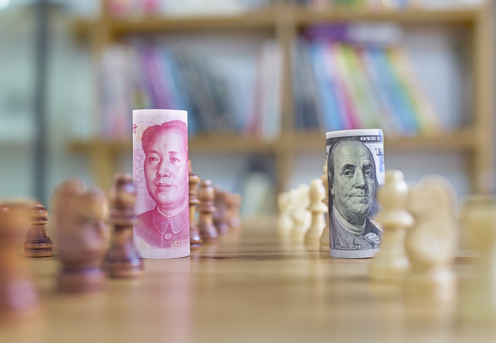 Wibest – USD to CNY: USD and CNY bills over a chess board.