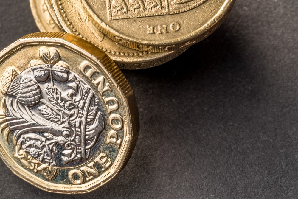 Wibest – USD GBP: A stack of British pound sterling coins.