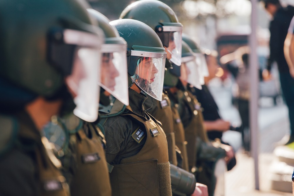 Wibest – Latin American Countries: A line of police forces getting ready to control a protest movement.
