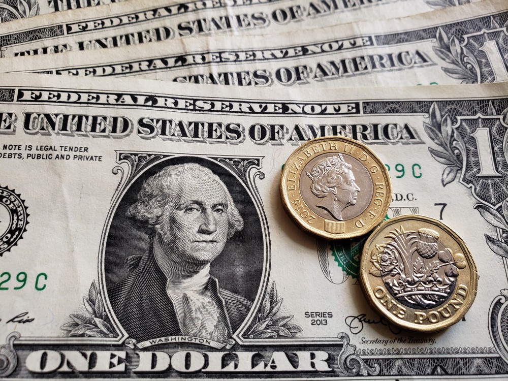 Wibest – GBP USD: US dollar bills and British pound coins.