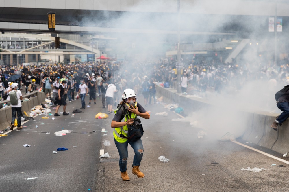 Wibest – Oil and Petroleum: Hong Kong's pro-democracy protesters trying to run clear from tear gas clouds. 