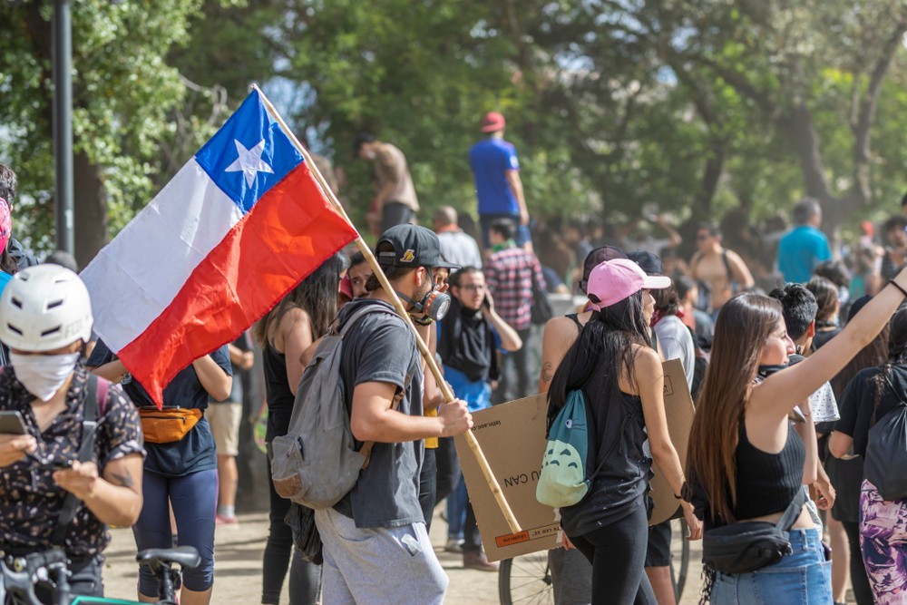 Wibest – Latin American Countries: Protesters holding the flag of Chile in Santiago De Chile, Chile. 