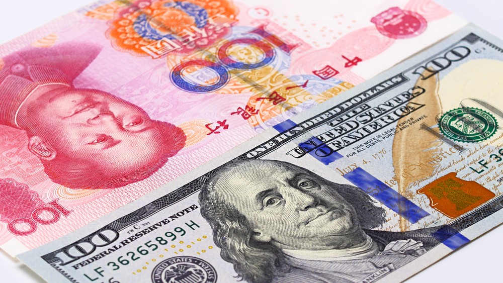 Wibest – USD to Chinese Yuan: Chinese yuan and US dollar bills.