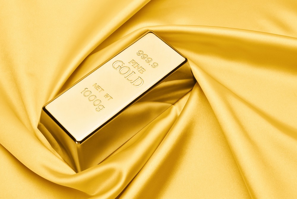 Wibest – Spot Gold Prices: Gold bar over a golden clothe.
