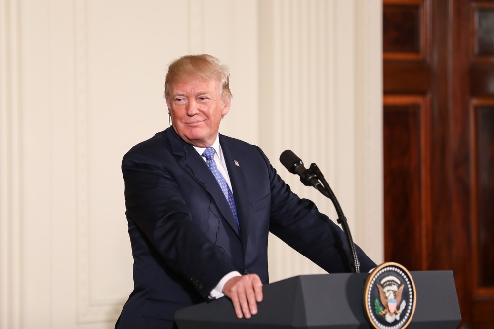 Wibest – Oil petroleum: US President Donald Trump standing in front of a podium and smiling.
