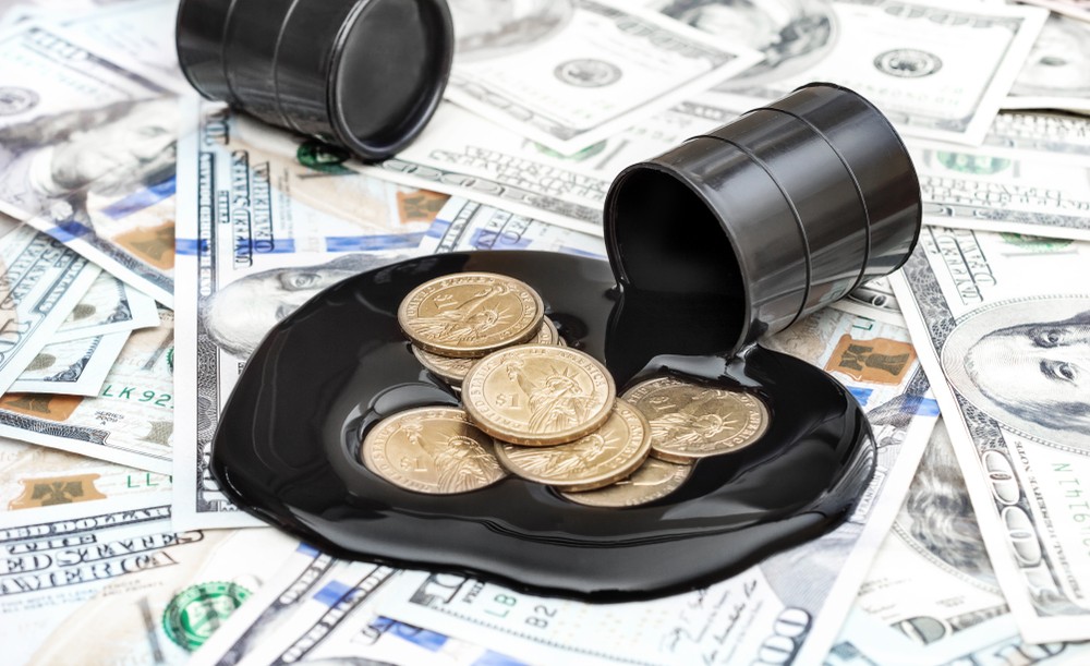 Wibest – Oil and petroleum: Oil barrel spilling crude over US dollar coins and bills.