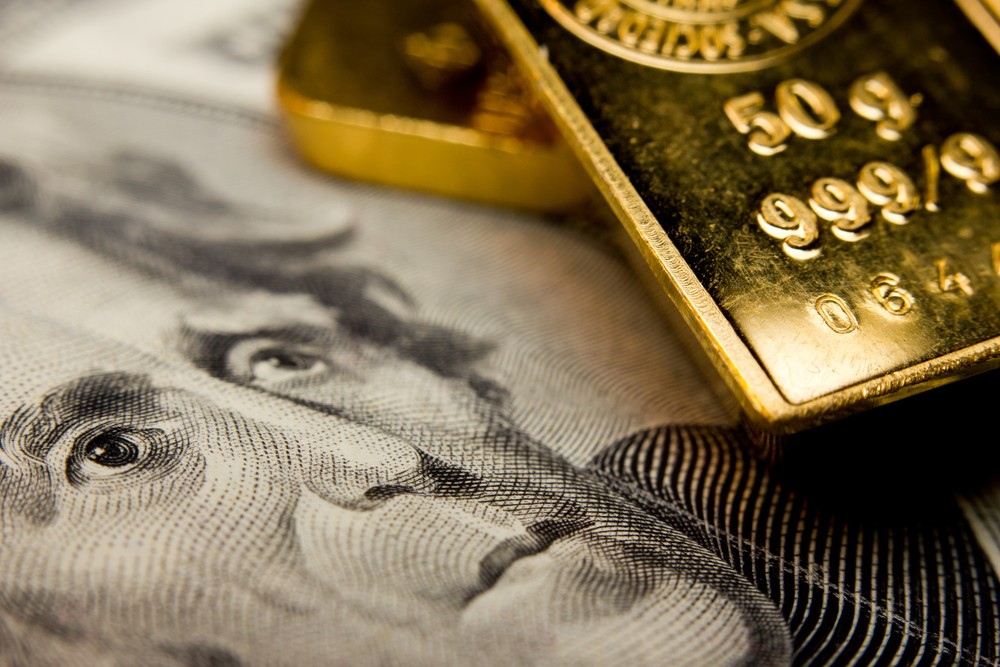 Wibest – Petroleum Crude: Gold bars on top of a US dollar bill.