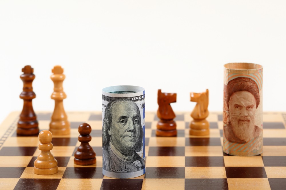 Wibest – Washington: US dollar bill and Iranian rial rial bill on a chess board.