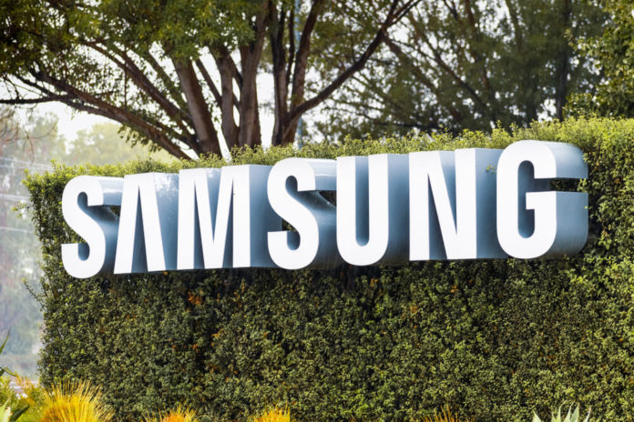 Samsung Sign displayed in front of the modern headquarters of Samsung Electronics Device Solutions.