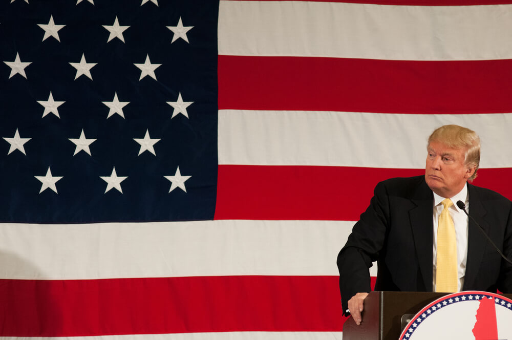 Donald Trump with USA flag background.