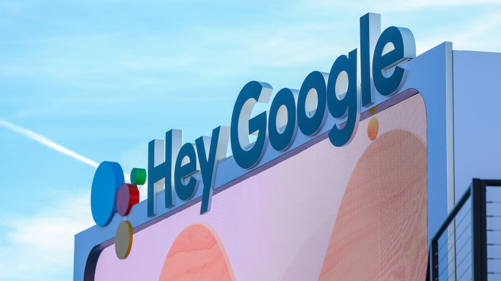 “Hey Google” written at the top of the temporary building with a large screen.