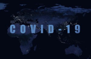 Coronavirus pandemic, word COVID-19 on night global map.