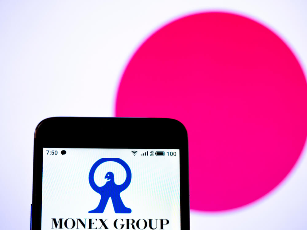 In this photo illustration the Monex Group, Inc. logo is seen displayed on a smartphone.