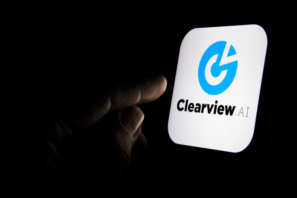 Clearview AI facial recognition software logo on the glowing screen.