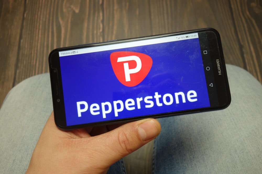 Pepperstone broker logo displayed on smartphone.