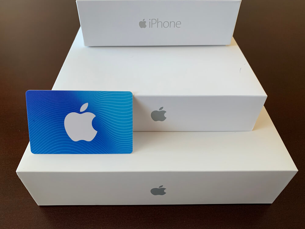 Apple product boxes with an Apple gift card