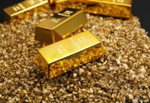Gold bars on nugget grains background