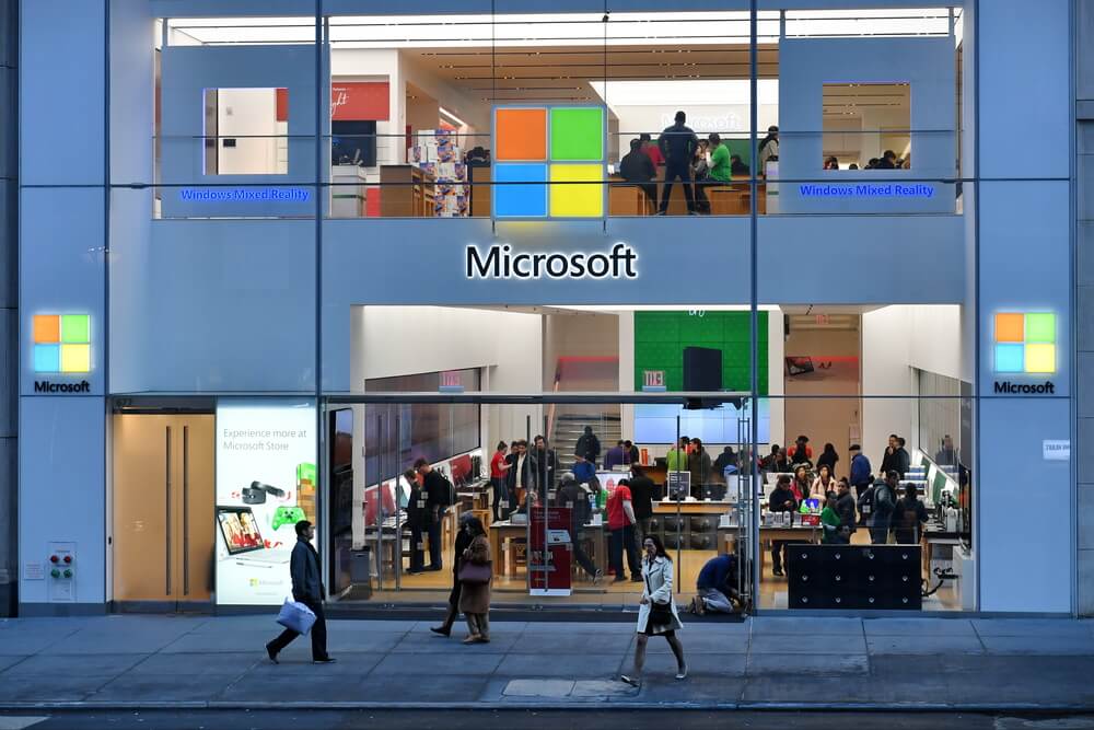 People walk past a Microsoft store 