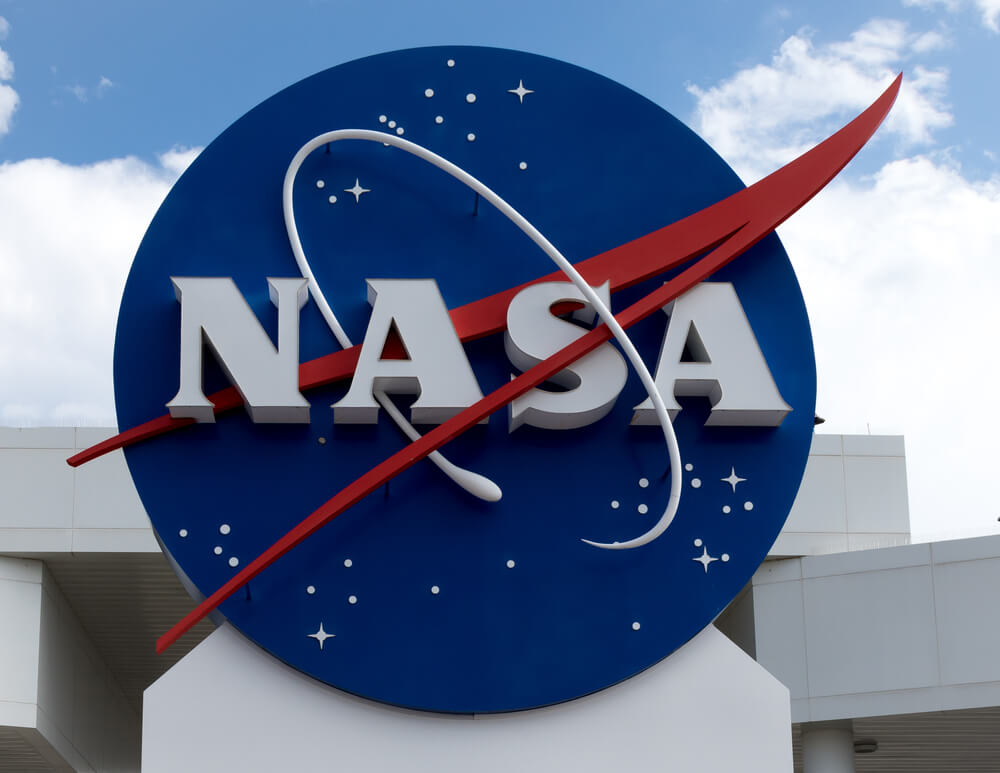 NASA logo with blue cloudy sky background