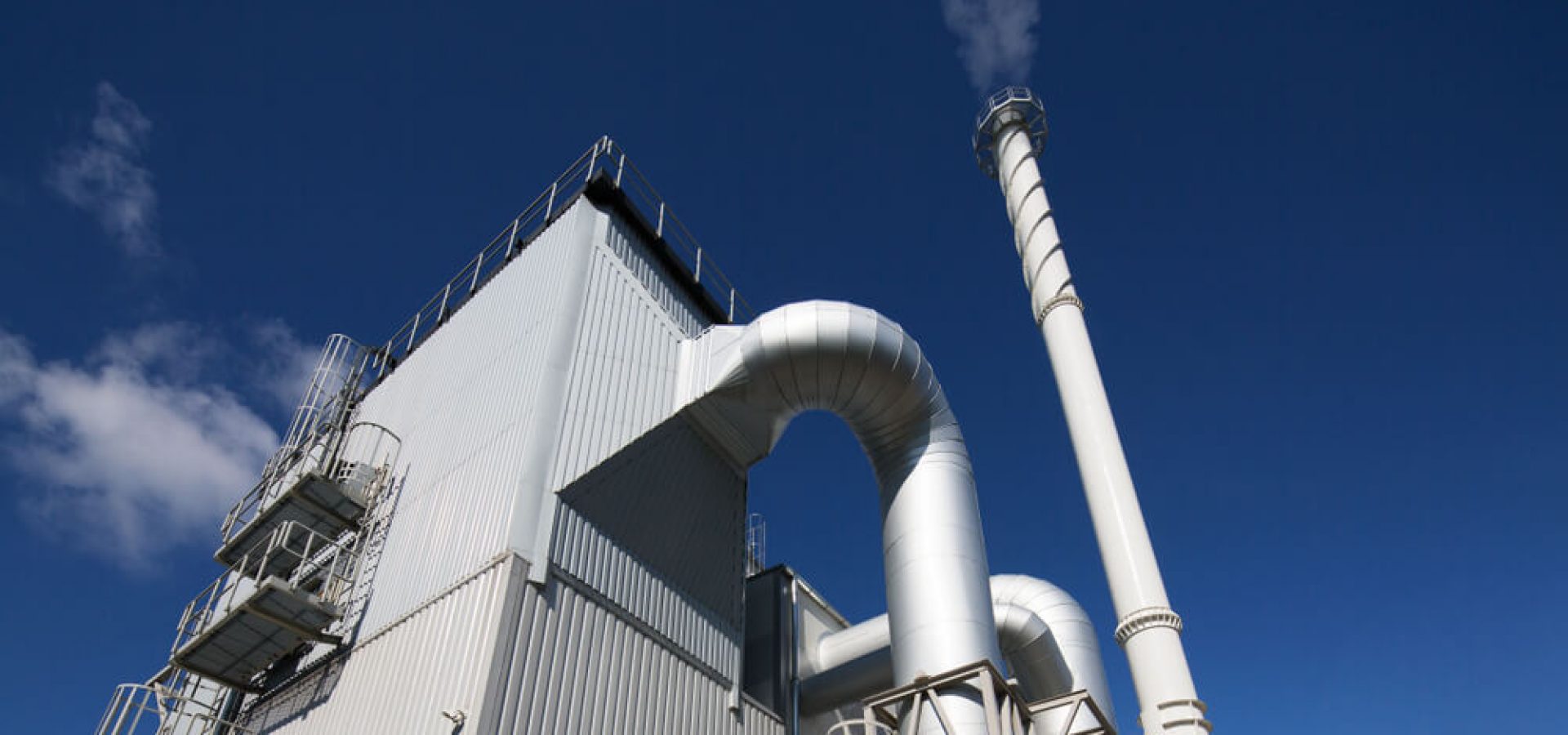 Biofuel Energy: Biofuel boiler house on a blue sky background