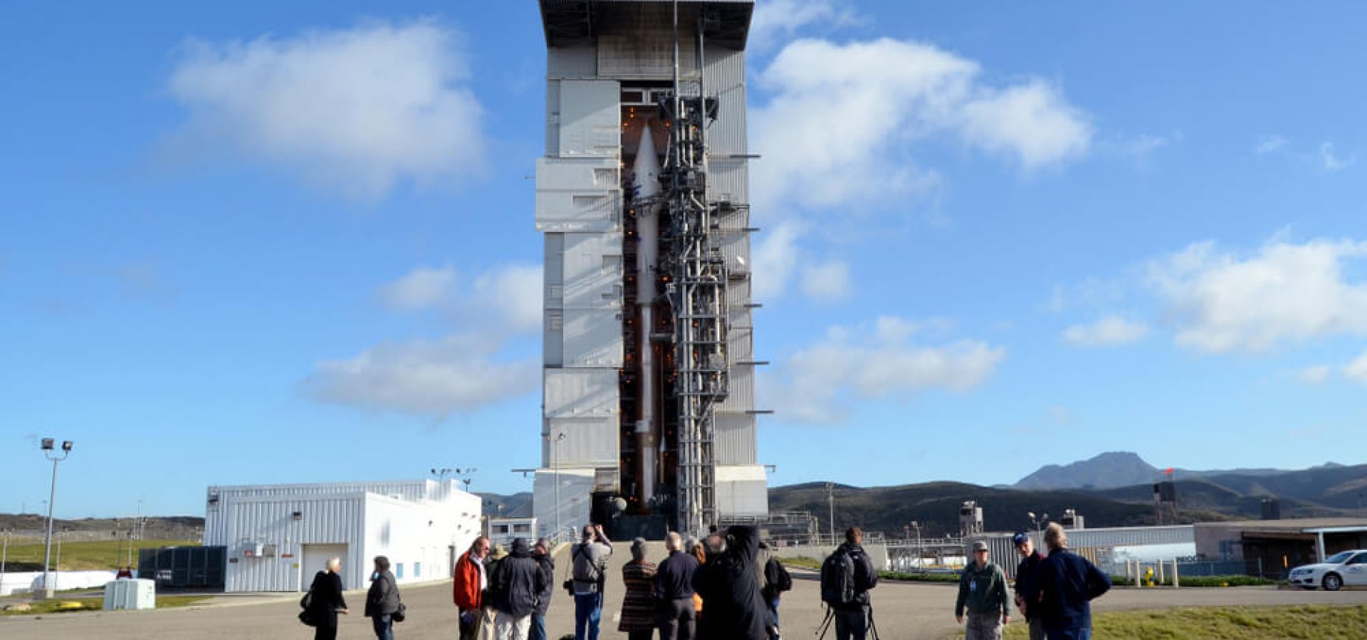 Members of the media view an Atlas V rocket