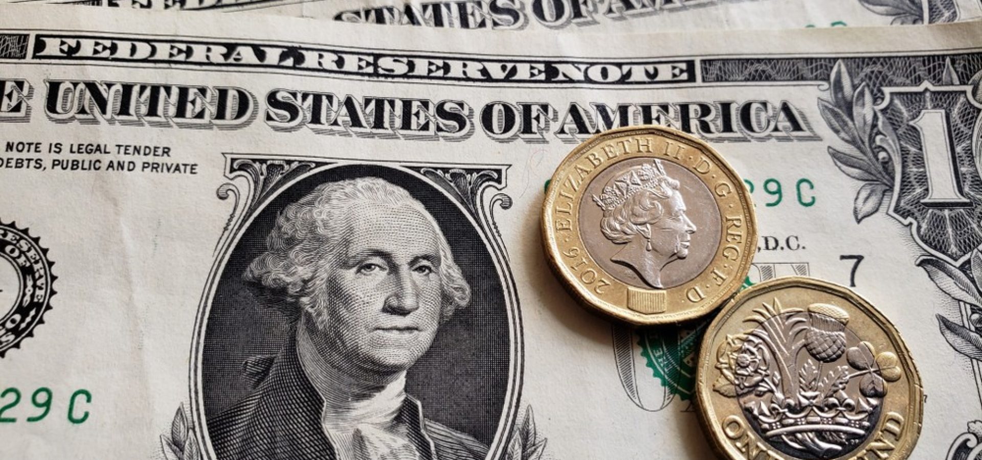 Wibest – GBP USD: US dollar bills and British pound coins.