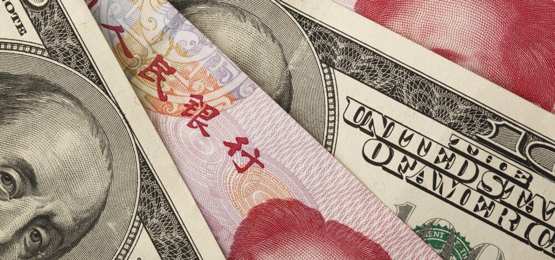 Forex Markets: Chinese yuan and US dollar bills.