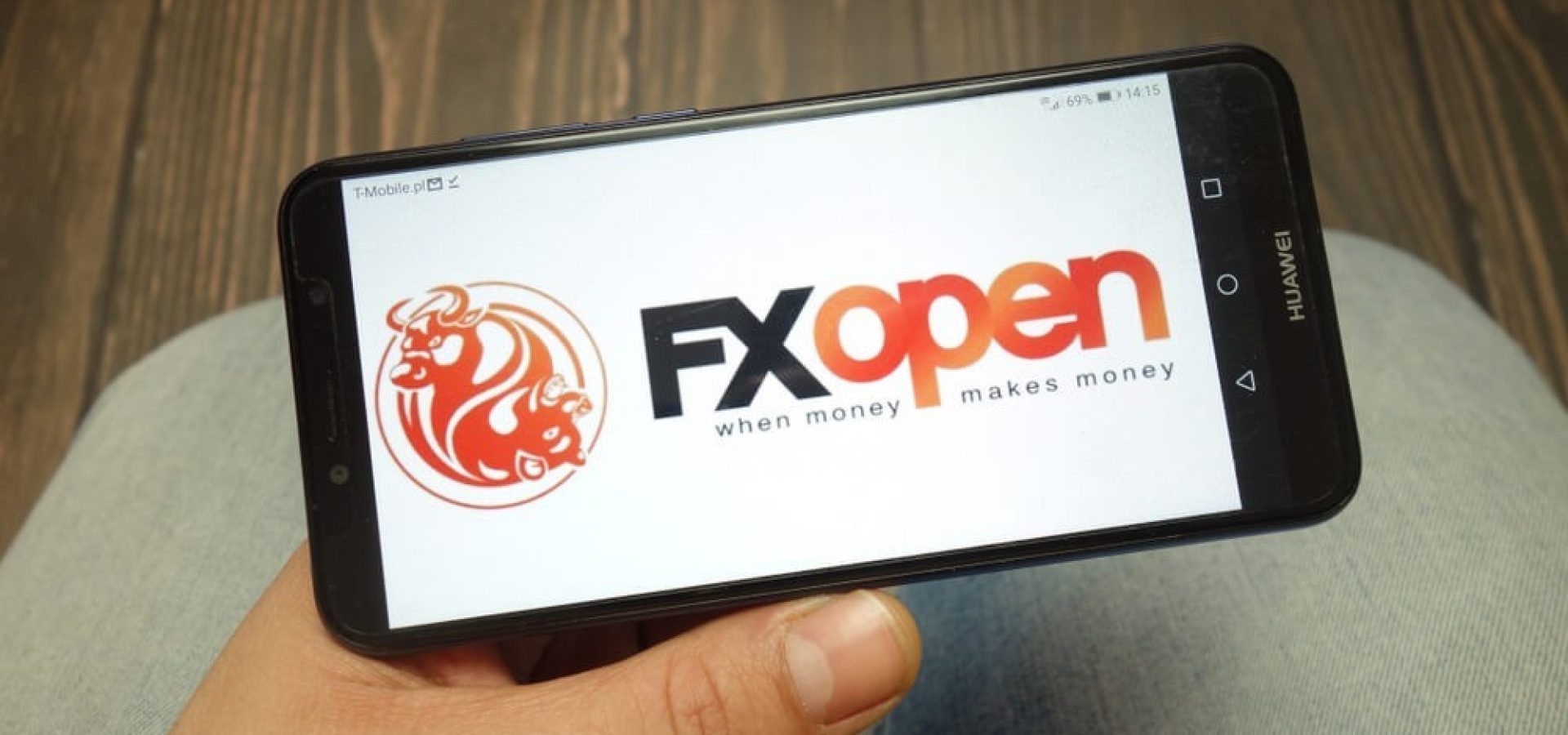 FXOpen: FXOpen broker logo displayed on smartphone.