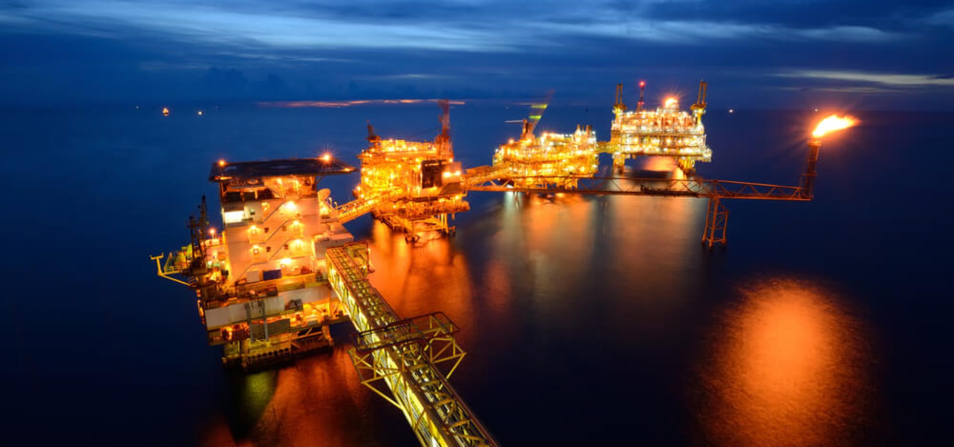 The large offshore oil rig at night with twilight background